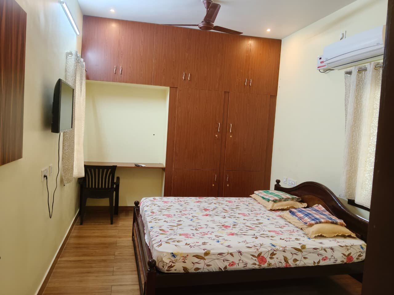 Spacious bedroom with window and furnishings